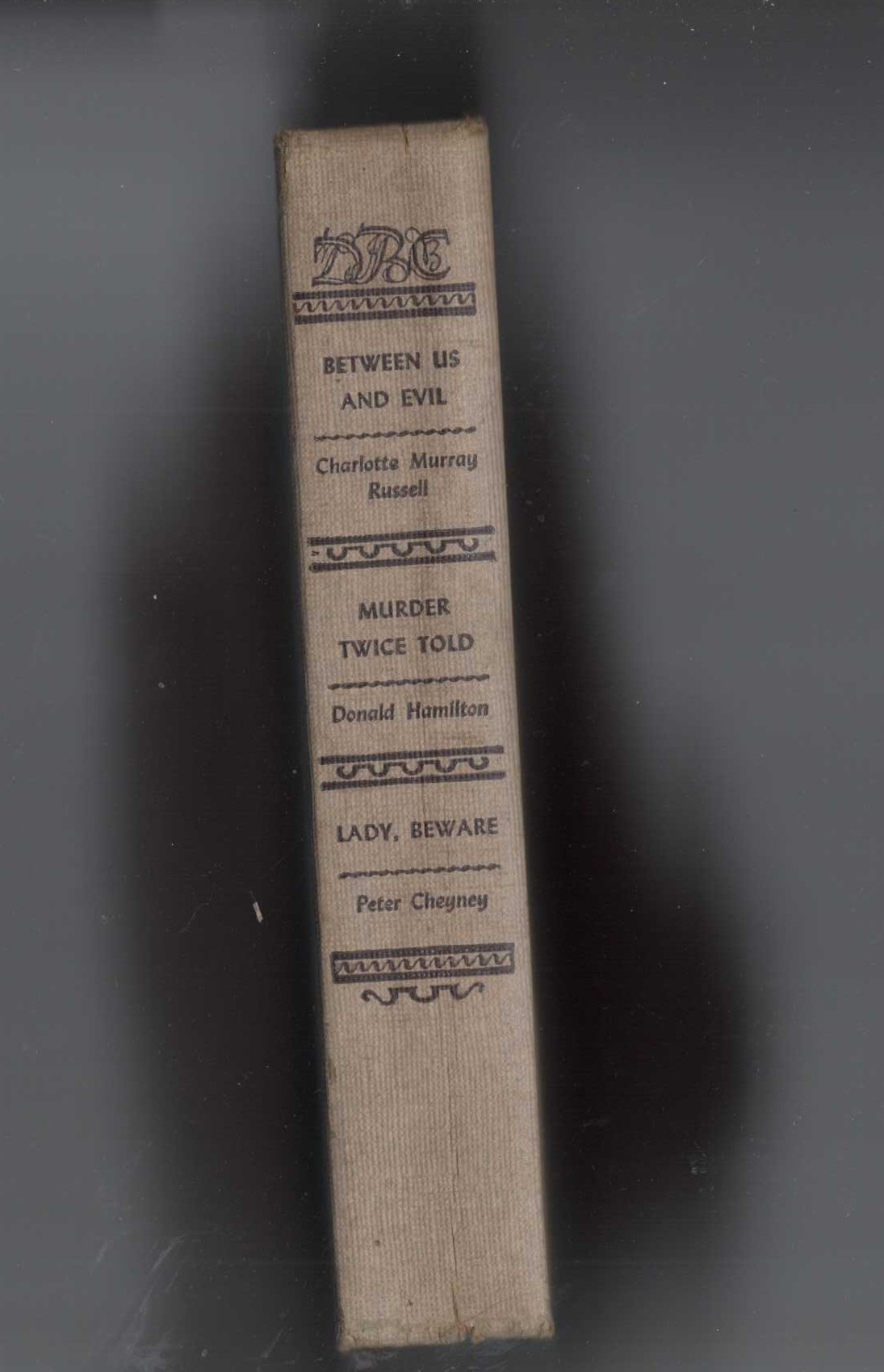 BETWEEN US AND EVIL (Russell) / MURDER TWICE TOLD (Hamilton) / LADY, BEWARE (Cheyney) front book cover image