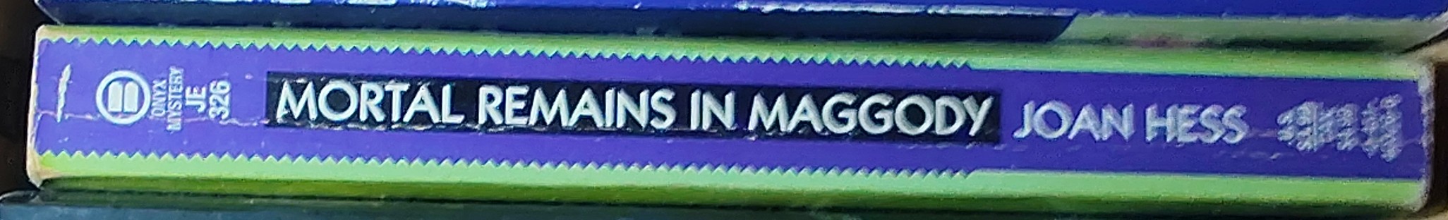 Joan Hess  MORTAL REMAINS spine of book image